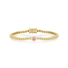 Crafted in 18-karat yellow gold, this Mini Bezel Tennis Bracelet is accented with an illusion set Pink Sapphire cabochon at the center. One of our favorite bracelets, it makes a stunning statement when worn alone or layered with other pieces from our collection. Wear yours as a signature piece, day to night and everywhere in between. Bracelet measures 6.5 inches in length Pink Sapphire accent measures 0.25" x 0.25" Each mini bezel measures 2.80mm x 2.80mm Push Clasp Fastening with Safety Availab Luxury Yellow Gold Diamond Bracelet With Gemstones, Elegant Cabochon Bracelets For Anniversary, Luxury Tennis Bracelet With Bezel Setting, Luxury Yellow Gold Stackable Beaded Bracelets, Luxury Gold Diamond Gemstone Bracelet, Luxury Yellow Gold Bracelets With Cabochon, Luxury Stackable Yellow Gold Beaded Bracelets, Luxury Yellow Gold Cabochon Bracelets, Luxury Bracelets With Bezel Setting And Round Cut