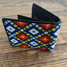 "Huichol wallet, mexican wallet, mexican gifts, mexican art, beaded wallet, mexican folk art, mexican style, huichol art Hey you, are you proud of your Mexican roots? This handmade wallet will make you proud of Mexico. It is an exclusive model of \"MEXICO EN LA PIEL\". Is a perfect Mexican gift. I'm sure you will get compliments from those who see them. DETAILS: - 4.5 x 3.5 inches - Hand embroidered by huichol artist - For bills, cards and IDs - With zipper - 100% leather - Embroidery whir MICRO Traditional Multicolor Wallet For Everyday Use, Traditional Multicolor Wallet, Traditional Handmade Multicolor Wallets, Traditional Multicolor Handmade Wallets, Beaded Wallet, Mexican Gifts, Leather Embroidery, Micro Beads, Handmade Wallet