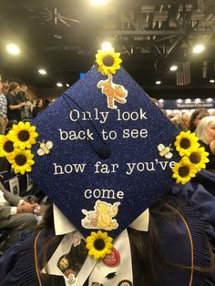 a blue graduation cap with sunflowers on it that says only look back to see how far you've come