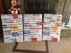 three candy bars are on display in front of a fire place with writing on them