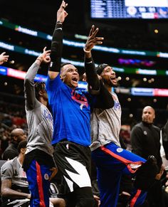 the basketball players are celebrating on the court