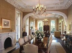 a formal dining room with chandelier, fireplace and large table in the center