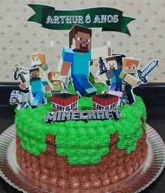 a cake decorated with minecraft characters on top of a glass plate and banner above it