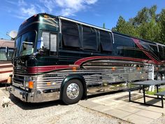 a large bus parked next to a picnic table