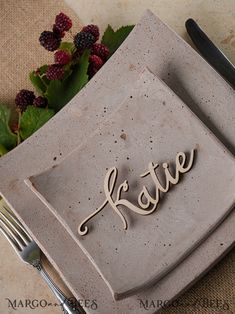 a plate with the word festive written on it next to a fork and knife