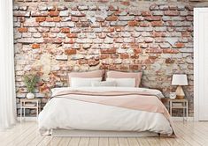 a brick wall in a bedroom with a bed and two nightstands next to it