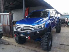 a blue truck parked in front of a building