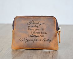 a brown leather wallet with the words i loved you on it