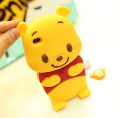 a person holding up a winnie the pooh phone case