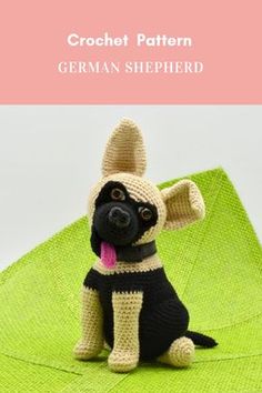 a crochet dog sitting on top of a green blanket with the words, german shepherd