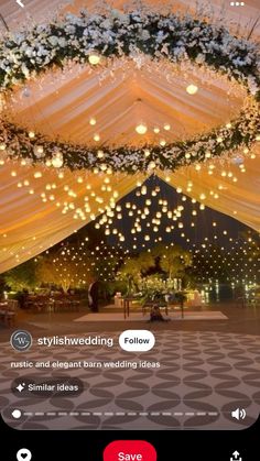 the inside of a tent decorated with lights and flowers