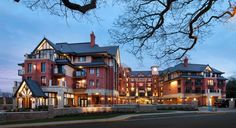 a large red brick building sitting next to a tree