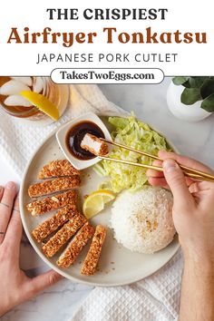 a plate with rice, lettuce and chicken on it next to chopsticks