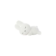 a white stuffed animal laying on its side