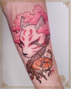 a woman's arm with a cat and tree tattoo on it