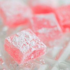 pink and white marshmallows sitting on top of each other