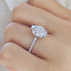 a woman's hand with a diamond ring on it