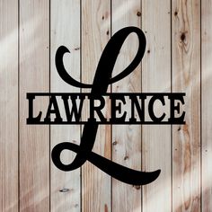 the word lawrence is placed on top of a wooden wall with wood planks