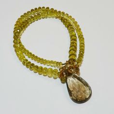 "DESCRIPTION: Thank you for coming in! A breath-takingly beautiful necklace made of an assortment of natural gemstones! You can find Lemon quartz, sunstone and a beautiful huge rutilated smoky quartz(23.6mmx37mm) in this one necklace! Premium quality gemstones finished with gold filled headpins and 18k solid yellow gold clasp! 18\" gorgeous necklace, 256 carats! You'll get the necklace you see! SIZE: 23.6mmx37mm center stone. GRADE: Transparent COLOR: Multi" Luxury Faceted Amber Jewelry, Faceted Briolette Citrine Jewelry, Faceted Citrine Briolette Necklace, Cluster Necklace, Sky Blue Topaz, Lemon Quartz, Beautiful Necklace, Gorgeous Necklaces, Wow Products