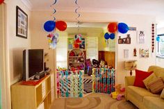 a living room filled with furniture and balloons