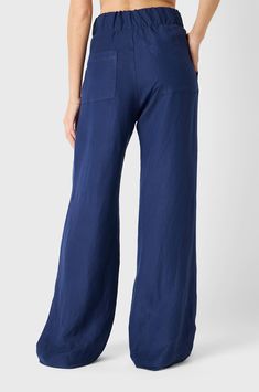 the Pleated Trouser boasts a high-waisted, wide-leg silhouette with exaggerated front pleat details. These pull-on trousers feature a wide elastic waistband with side and back pockets. Made from a lightweight Linen Rayon with gorgeous drape, these pants go seamlessly from day to night. Pair them with any of our tanks and the matching Duster for an effortlessly polished. Made in the USA from Japanese Textiles55% Linen 45% Rayon Model is 5’9” and wearing a size 2 for length Navy Linen, Pleated Trousers, Women's Tops, Nautical, New Arrivals, High Waist, Wide Leg, Size 2, Trousers