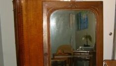 an antique grandfather mirror in the corner of a room