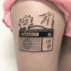 a woman's thigh with a radio tattoo on it