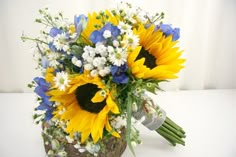 a bouquet of sunflowers and white daisies