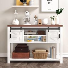 a shelf with some books and other items on it next to a wall mounted poster