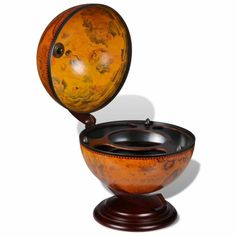 an orange and black bowl sitting on top of a wooden stand