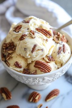 a bowl filled with ice cream and pecans