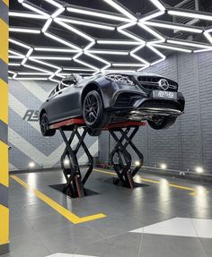 a car on a lift in a garage