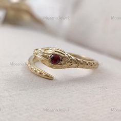 ✥✥  Ring Detail ✥✥ ♦ Main Stone: CZ Diamond  ♦ Main Stone Shape: Round Cut ♦ Main Stone Size: 2.60mm  ♦ Main Stone Color: Ruby  ♦ Metal: Sterling Silver, 10K/14K/18K Solid Gold, Or Platinum ♦ Finish Options: Yellow / Rose / White ♦ Free Shipping For the USA ♦ Free Engraving ♦ Nickle Free ✥ P E R S O N A L I S A T I O N ✥     ♦ If you like the ring design to be customized, we will gradually accept your idea and will try to put it into design. ♦ Choose your ring size while ordering. If the ring size is not listed in the option, then please contact me. ✥ O T H E R ∙ I N F O R M A T I O N ✥  ♦ Your item will be nicely packed to gift in elegant jewelry boxes. ♦ Some pictures show the listed engagement ring with various bands just to show how versatile it looks when paired with them, but they ar Unique Yellow Gold Snake-shaped Ring, Gemstone Snake Ring Fine Jewelry, Adjustable Unique Yellow Gold Snake Ring, Adjustable Yellow Gold Snake-shaped Ring, Antique Snake-shaped Yellow Gold Jewelry, Gothic Rings, Snake Ring, Cz Diamond, Round Cut