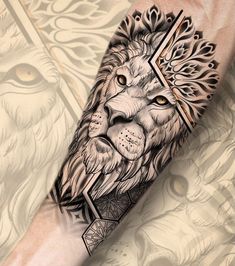 a lion tattoo on the arm with an intricate cross in it's centerpiece