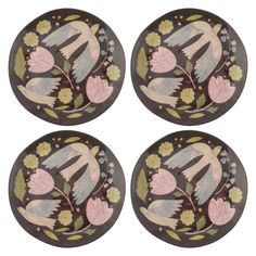 four plates with flowers and leaves painted on the front, one is brown and three are pink