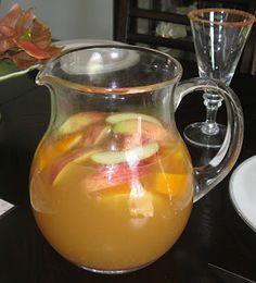 a pitcher filled with liquid sitting on top of a table