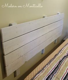 a wooden headboard sitting on top of a bed