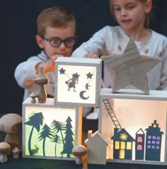 two young children playing with wooden blocks and toys on a table in front of them