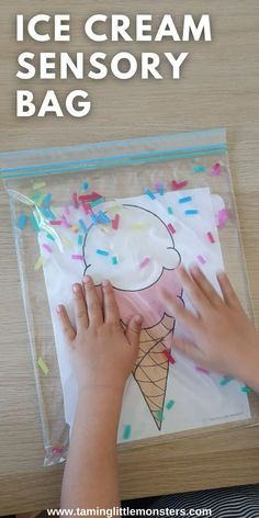 an ice cream bag with sprinkles on it and someone's hands