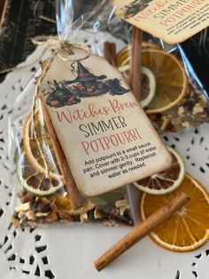 an orange slice and cinnamon stick sitting on top of a white doily covered table