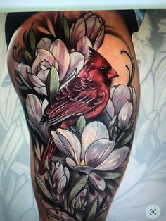 a woman's thigh with flowers and a cardinal on it