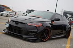 a black sports car parked in a parking lot