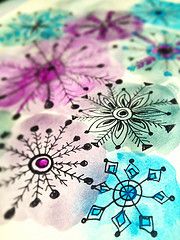 an image of some snowflakes on a tablecloth with watercolors and ink