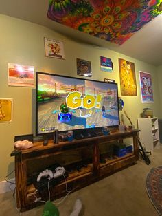 a flat screen tv sitting on top of a wooden entertainment center