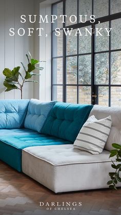 a blue and white couch sitting in front of a window with the words modular sofas for your unique home