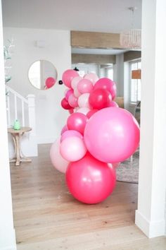 pink and white balloons are on the floor