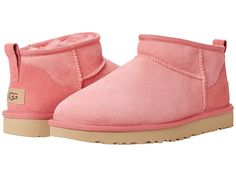 UGG Classic Ultra Mini - Women's Shoes : Pink Blossom : The cute and cozy slip-on-and-go UGG Classic Ultra Mini ankle boot features water-repellent Twinface sheepskin uppers with overlock stitch detailing on seams and a rear pull tab. Leather heel label with embossed UGG logo and polyester bindings. Offers 17mm of sheepskin linings, and a footbed lined with 17mm of UGGplush made from 80% wool and 20% lyocell. Treadlite by UGG outsole provides increased traction, durability, cushioning and flexib Pink Ultra Mini Uggs, Pink Mini Uggs, Ankle Uggs, Ugg Collection, Pink Ugg Slippers, Ultra Mini Ugg, Pink Ugg Boots, Pink Uggs, Mini Boots