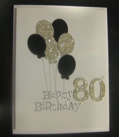 an 80th birthday card with black and white balloons in glitter on the bottom,