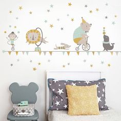 a child's bedroom with a wall sticker that has animals and stars on it