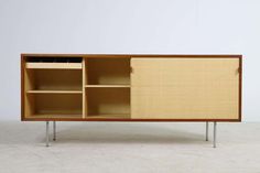 the sideboard is made out of wood and has two compartments on each side, with metal legs